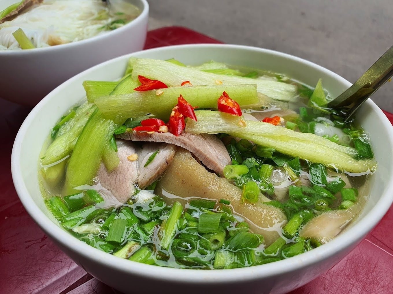 Clear noodle soup with translucent porkballs in light broth 